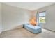 Neutral bedroom with a twin bed, side table, and a large window providing natural light at 1447 Myrtle Oaks Trl, Oviedo, FL 32765
