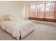 Bedroom with neutral carpet, a large window with blinds, and a comfortable bed at 1447 Myrtle Oaks Trl, Oviedo, FL 32765