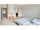 Inviting bedroom with neutral carpet, minimalist decor, and easy access to the ensuite bathroom at 1447 Myrtle Oaks Trl, Oviedo, FL 32765