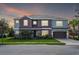 Beautiful two-story home boasts a two-car garage, manicured lawn and a combination of stucco and siding at 1447 Myrtle Oaks Trl, Oviedo, FL 32765