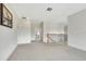 Spacious second-floor hallway with neutral carpet and staircase featuring black metal and wood at 1447 Myrtle Oaks Trl, Oviedo, FL 32765