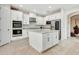 Bright and open kitchen features stainless appliances, white cabinets, and granite countertops at 1447 Myrtle Oaks Trl, Oviedo, FL 32765