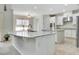 Bright kitchen features granite countertops, a large center island, white cabinetry and stainless appliances at 1447 Myrtle Oaks Trl, Oviedo, FL 32765