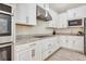 Bright kitchen features white cabinets, stainless steel appliances, and granite countertops at 1447 Myrtle Oaks Trl, Oviedo, FL 32765