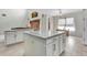 This eat-in kitchen features granite countertops, a large island and white cabinets with stainless appliances at 1447 Myrtle Oaks Trl, Oviedo, FL 32765