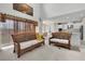 Open living room showcasing wicker furniture, neutral carpet, high ceilings, and a glimpse of the adjacent kitchen at 1447 Myrtle Oaks Trl, Oviedo, FL 32765