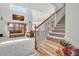 Bright living room boasts a staircase, wicker furniture, neutral carpet, and large windows with lots of light at 1447 Myrtle Oaks Trl, Oviedo, FL 32765