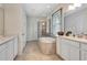 Bright bathroom features a soaking tub, glass shower, and double vanity at 1447 Myrtle Oaks Trl, Oviedo, FL 32765