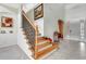 Elegant staircase featuring wood and wrought iron with tiled entry and decorative niche at 1447 Myrtle Oaks Trl, Oviedo, FL 32765