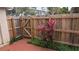 Fenced backyard with tropical plants and a privacy fence at 1617 Shady Ridge Ct # 257, Orlando, FL 32807