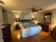 Relaxing main bedroom featuring wood floors, ceiling fan, and neutral tones, promoting a peaceful ambiance at 1627 Tampico Pl, The Villages, FL 32159