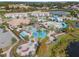 Aerial view of a community waterpark with pool, slides, and clubhouse at 207 Aidans Lndg, Haines City, FL 33844
