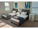 Bright bedroom with twin beds, neutral walls and soft carpet at 207 Aidans Lndg, Haines City, FL 33844