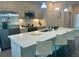 Modern kitchen featuring stainless steel appliances, a large island, and ample cabinet space at 207 Aidans Lndg, Haines City, FL 33844