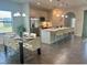Open-concept kitchen and dining area with stainless steel appliances and ample seating at 207 Aidans Lndg, Haines City, FL 33844
