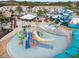 Resort-style community pool with multiple water slides, splash area, and gathering space for outdoor entertainment at 207 Aidans Lndg, Haines City, FL 33844