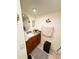A bathroom vanity with a sink and mirror, providing a convenient and stylish space at 207 Jacaranda Dr, Leesburg, FL 34748