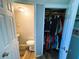 Bathroom with a vanity sink adjacent to closet space for storage at 207 Jacaranda Dr, Leesburg, FL 34748