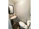 Small bathroom with a pedestal sink, decorative mirror, and tile floor at 207 Jacaranda Dr, Leesburg, FL 34748