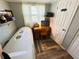 Compact bedroom featuring a tanning bed, desk, and natural light at 207 Jacaranda Dr, Leesburg, FL 34748