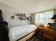 Bedroom with a personal tanning bed, desk, and bright natural light at 207 Jacaranda Dr, Leesburg, FL 34748