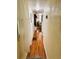 A hallway with wood floors provides access to the other rooms in the home at 207 Jacaranda Dr, Leesburg, FL 34748