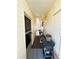 Exterior view of hallway featuring grill and a door leading to the outdoors at 207 Jacaranda Dr, Leesburg, FL 34748