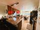 Open kitchen featuring dark cabinetry, granite countertops, stainless steel appliances, and a cozy breakfast nook at 207 Jacaranda Dr, Leesburg, FL 34748