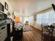 Cozy living room bathed in natural light featuring hardwood floors at 207 Jacaranda Dr, Leesburg, FL 34748