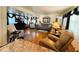 Spacious living room with hardwood floors, comfortable seating, and a large TV at 207 Jacaranda Dr, Leesburg, FL 34748