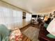 Cozy living room featuring hardwood floors, bright windows, and a comfortable seating area at 207 Jacaranda Dr, Leesburg, FL 34748