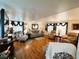 Comfortable living room with hardwood floors, neutral decor, and large TV at 207 Jacaranda Dr, Leesburg, FL 34748