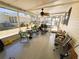 Spacious screened-in porch with comfortable seating, a ceiling fan, and views of the surrounding neighborhood at 207 Jacaranda Dr, Leesburg, FL 34748