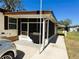 View of the enclosed porch, with an outdoor grill, covered from insects for outdoor enjoyment at 207 Jacaranda Dr, Leesburg, FL 34748