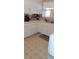 Well-lit kitchen with neutral countertops and cabinetry, providing a practical space for cooking and meal preparation at 225 E Cummings St, Lake Alfred, FL 33850