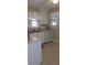 Bright kitchen featuring white appliances and ample cabinet space, offering functionality and a clean aesthetic at 225 E Cummings St, Lake Alfred, FL 33850