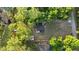 Aerial view of property shows the lake, dock, outbuildings and lush privacy at 2449 E Lake Dr, Deland, FL 32724