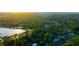 Expansive aerial view of neighborhood and nearby lake at sunset at 2449 E Lake Dr, Deland, FL 32724