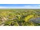Aerial view of the property surrounded by a beautiful landscape and a tranquil lake at 2449 E Lake Dr, Deland, FL 32724