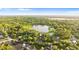 Gorgeous aerial view of the property by a lake and beautiful landscaping at 2449 E Lake Dr, Deland, FL 32724