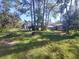 Backyard of house with a fire pit, shed and lots of lush green grass and shade at 2449 E Lake Dr, Deland, FL 32724