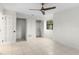 Light bedroom with ceiling fan, white closet doors and tile floors at 2449 E Lake Dr, Deland, FL 32724