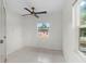 Bedroom with tile floors and ceiling fan at 2449 E Lake Dr, Deland, FL 32724