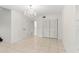 Bedroom with tile floors, closet and decorative chandelier at 2449 E Lake Dr, Deland, FL 32724