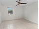 Light bedroom with tile flooring and ceiling fan at 2449 E Lake Dr, Deland, FL 32724