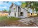Exterior shot with a gray siding and spacious front yard at 2449 E Lake Dr, Deland, FL 32724