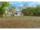 View of a two-story home, with a spacious yard, offering a serene and private setting at 2449 E Lake Dr, Deland, FL 32724