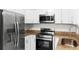 Kitchen featuring stainless steel appliances and granite countertops at 2449 E Lake Dr, Deland, FL 32724