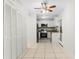 Well-lit kitchen with white cabinets, stainless steel appliances, and tile flooring at 2449 E Lake Dr, Deland, FL 32724