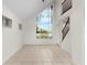 Well-lit living room with big windows and tiled floor at 2449 E Lake Dr, Deland, FL 32724